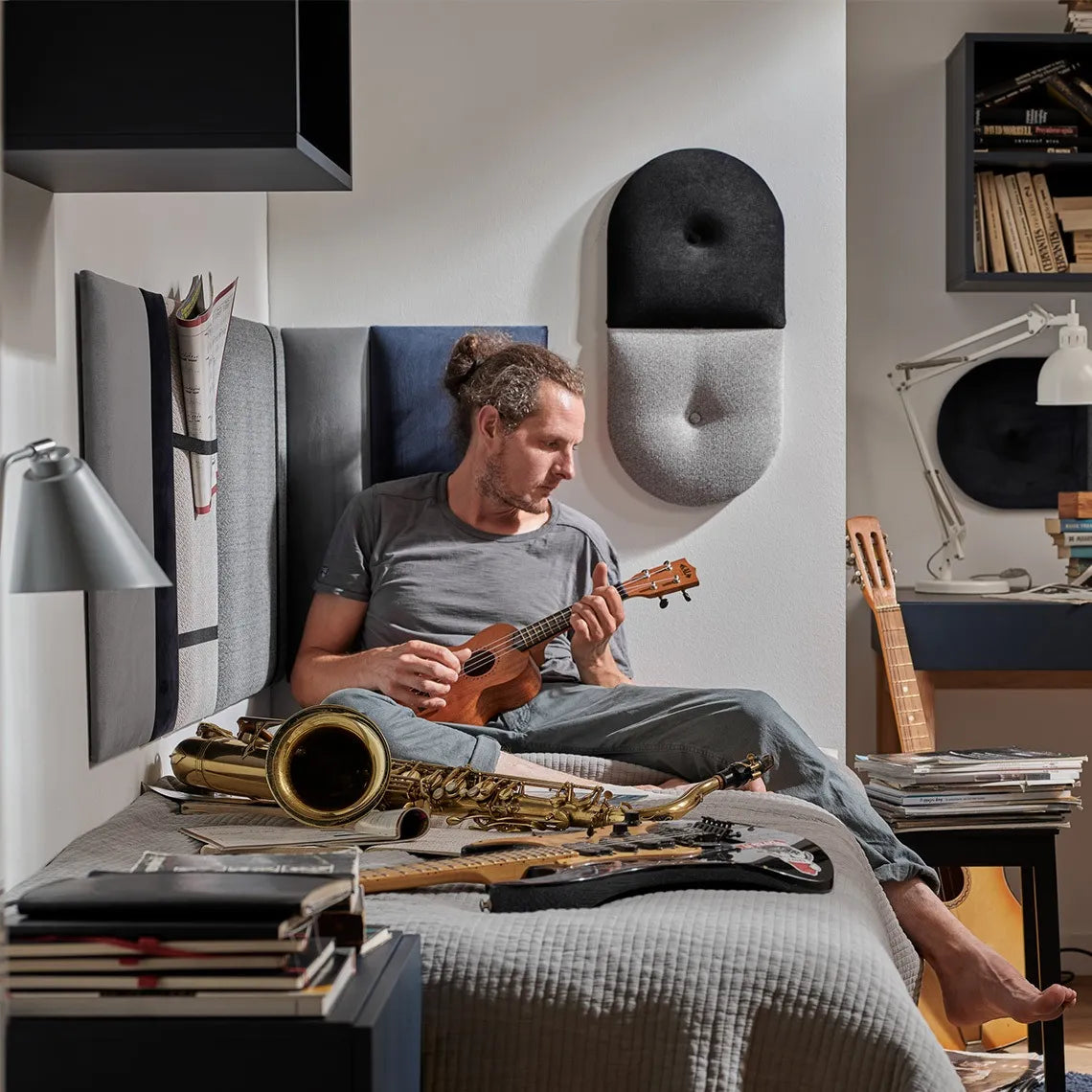 Padded Wall Panels Set 1 Grey in bedroom interior with a man playing instruments Decormania UK